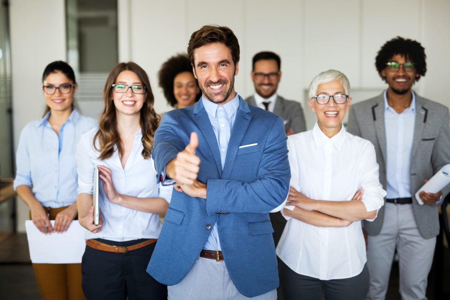 Group of successful multiethnic business people celebrating a good job in the office