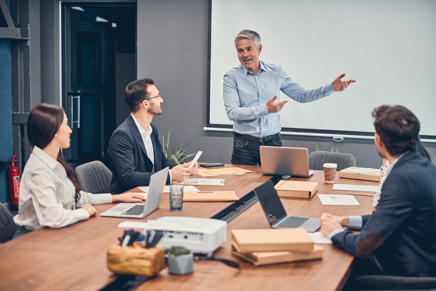 Managers discussing new startup project with boss in office